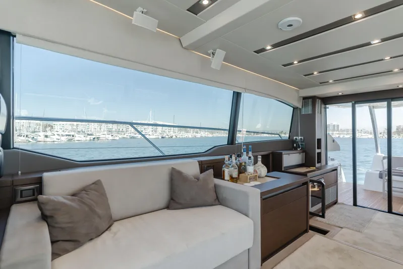 Seaduction Yacht Photos Pics Luxurious interior of 2018 Prestige 630 yacht with panoramic windows and elegant seating.