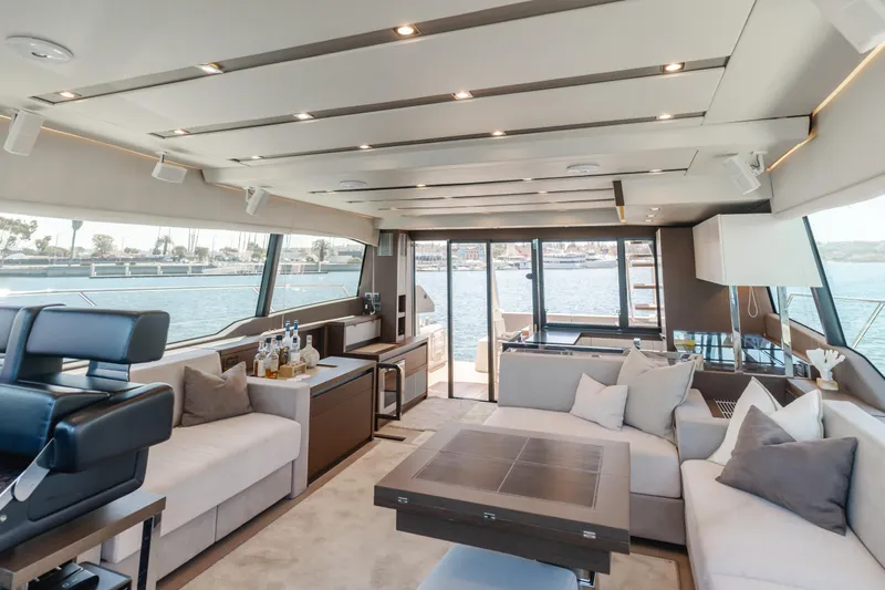 Seaduction Yacht Photos Pics Luxurious interior of 2018 Prestige 630 yacht with elegant seating and panoramic windows.