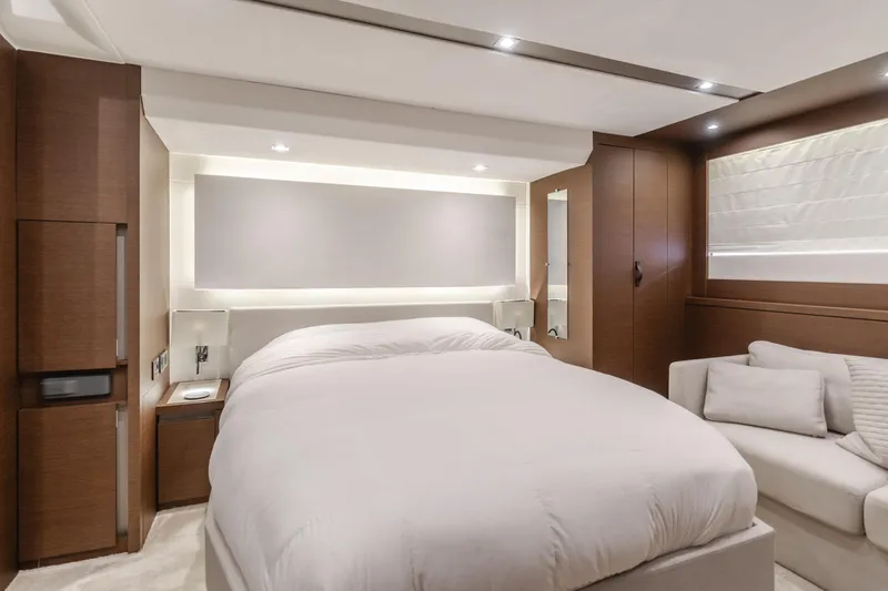 Seaduction Yacht Photos Pics Luxurious bedroom interior in 2018 Prestige 630 yacht, featuring modern design and cozy ambiance.
