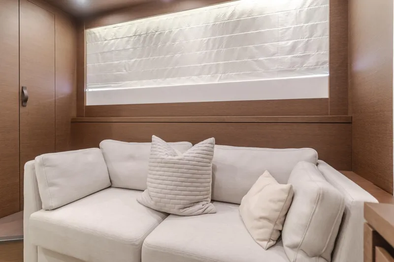 Seaduction Yacht Photos Pics Luxurious interior of 2018 Prestige 630 yacht with cozy white sofa and cushions.