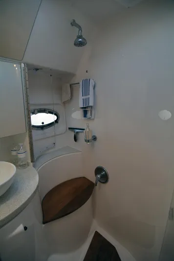  Yacht Photos Pics 2018 Regal 46 Sport Coupe bathroom with shower, wooden seat, and modern fixtures.