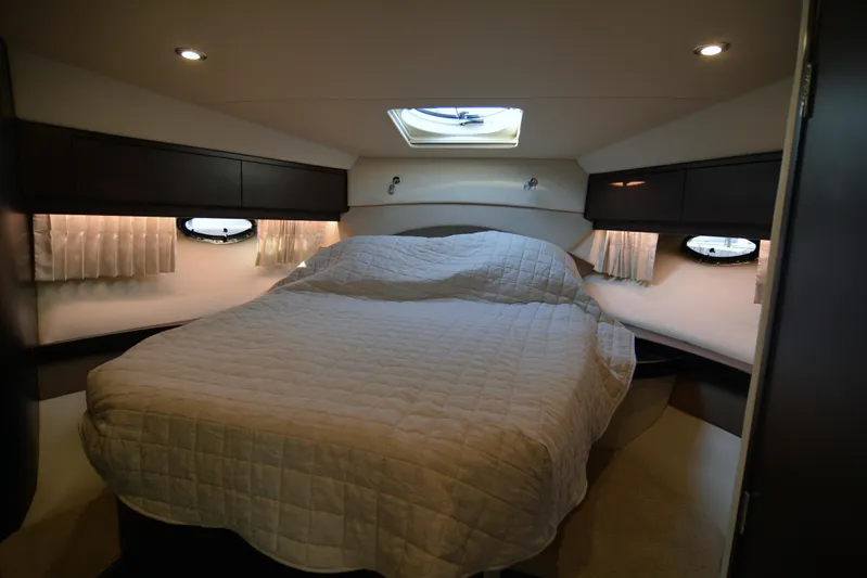  Yacht Photos Pics Luxurious cabin interior of 2018 Regal 46 Sport Coupe with cozy bed and ambient lighting.