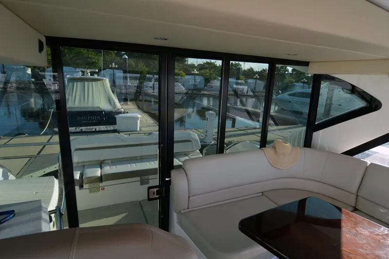  Yacht Photos Pics Interior view of 2018 Regal 46 Sport Coupe yacht with docked boats outside.