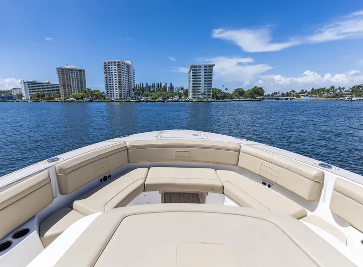  Yacht Photos Pics 2020 Pursuit S 368 Sport boat on water with city skyline in background.