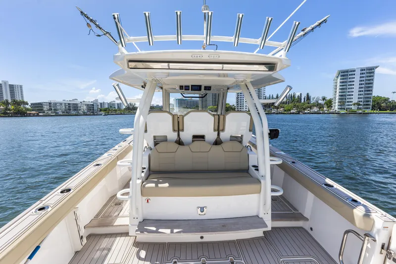  Yacht Photos Pics 2020 Pursuit S 368 Sport boat interior with seating, on a sunny day by the water.