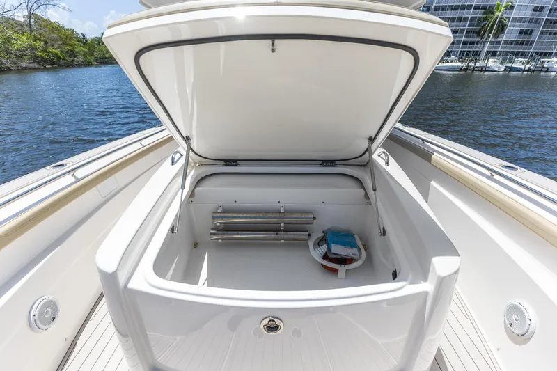  Yacht Photos Pics Open storage compartment on 2020 Pursuit S 368 Sport boat, docked by water.