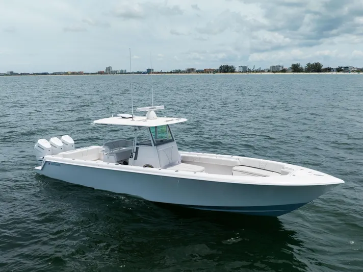  Yacht Photos Pics 2024 Contender 39 ST boat on open water, featuring triple outboard engines.