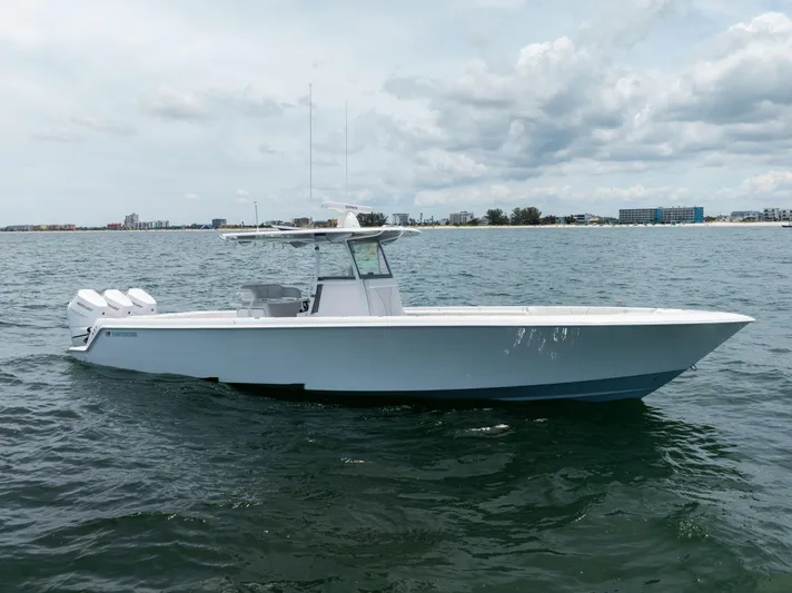  Yacht Photos Pics 2024 Contender 39 ST boat on open water, featuring triple outboard engines.