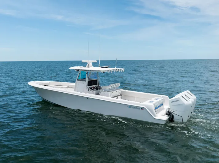  Yacht Photos Pics 2024 Contender 39 ST boat cruising on open ocean under clear blue sky.