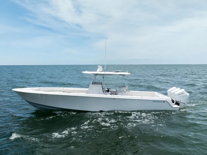  Yacht Photos Pics 2024 Contender 39 ST boat cruising on open sea under clear sky.