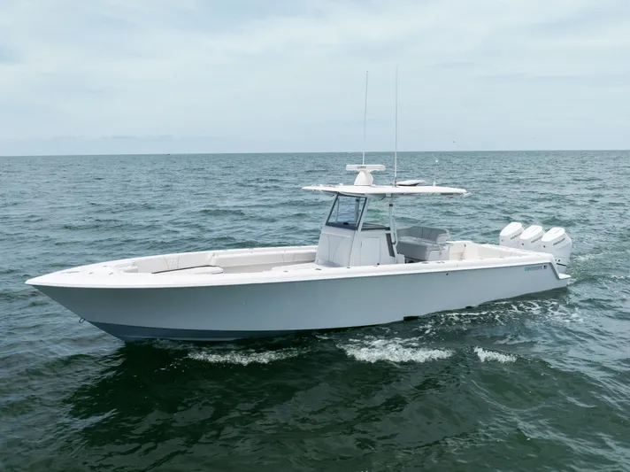  Yacht Photos Pics 2024 Contender 39 ST boat cruising on open water, showcasing sleek design and powerful engines.