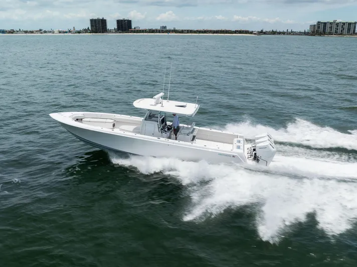  Yacht Photos Pics 2024 Contender 39 ST boat cruising on open water, showcasing sleek design and powerful engines.