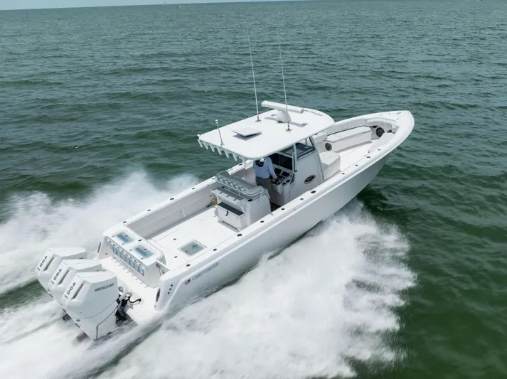  Yacht Photos Pics 2024 Contender 39 ST boat cruising on open water with powerful engines.