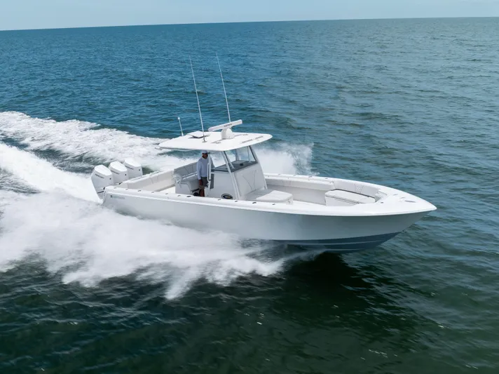  Yacht Photos Pics 2024 Contender 39 ST boat cruising on open water, showcasing sleek design and powerful engines.