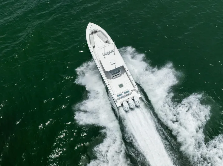  Yacht Photos Pics 2024 Contender 39 ST boat cruising on open water, aerial view.