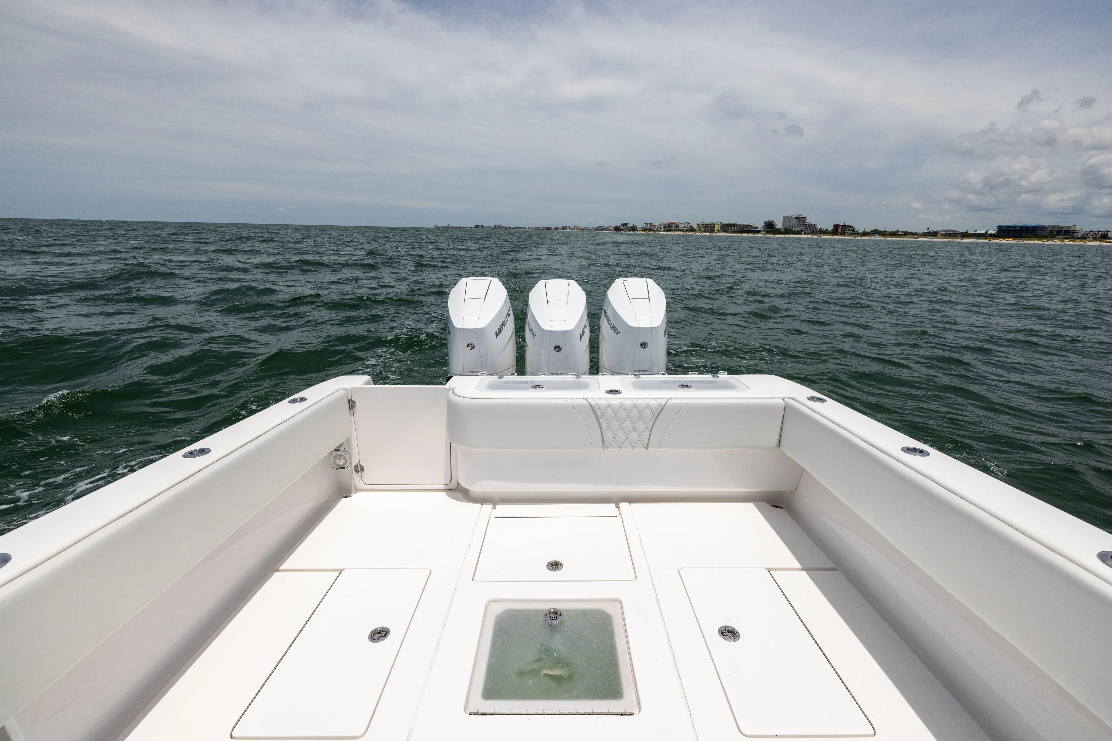  Yacht Photos Pics 2024 Contender 39 ST boat with triple engines on open water.