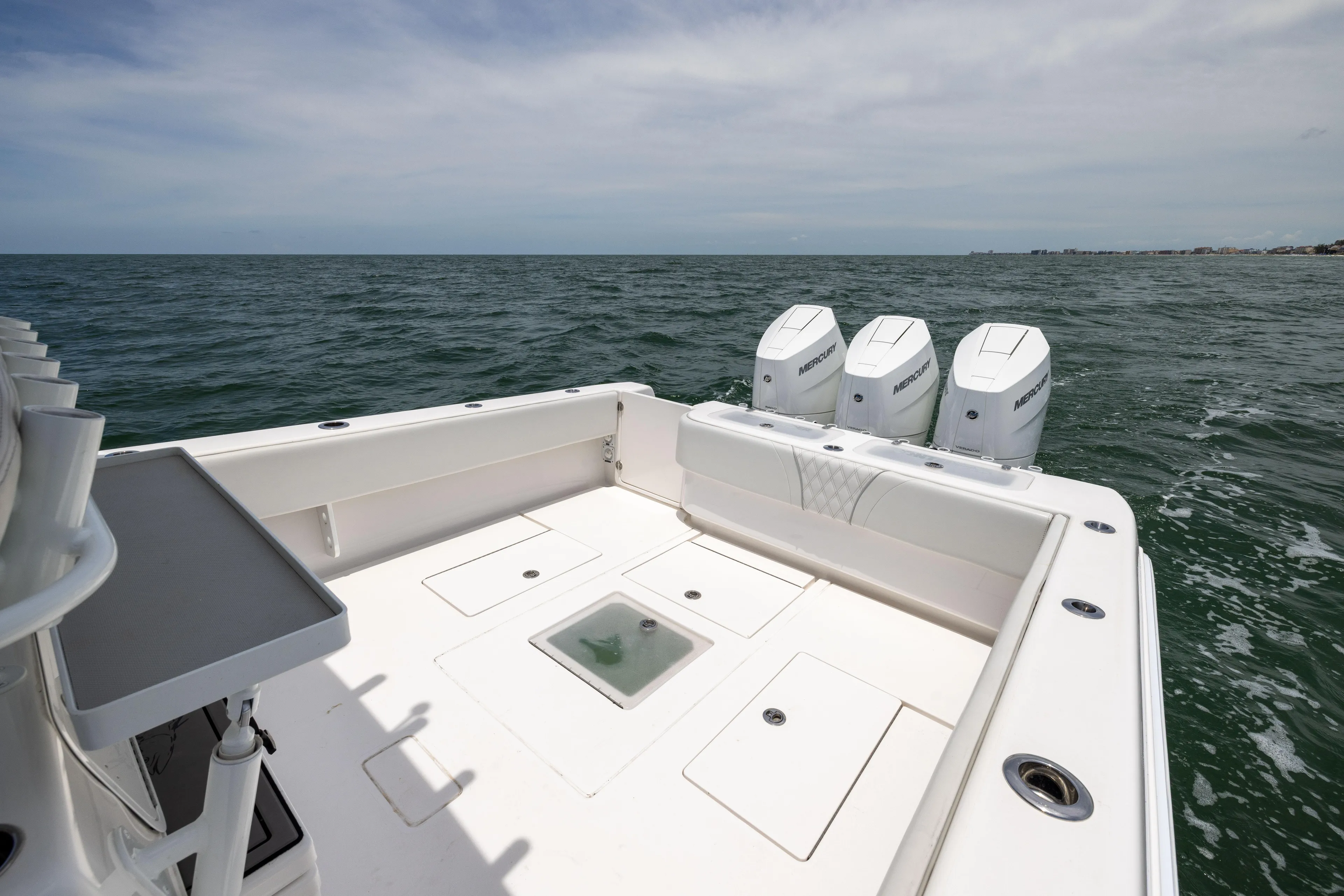  Yacht Photos Pics 2024 Contender 39 ST boat with triple Mercury engines on open sea.