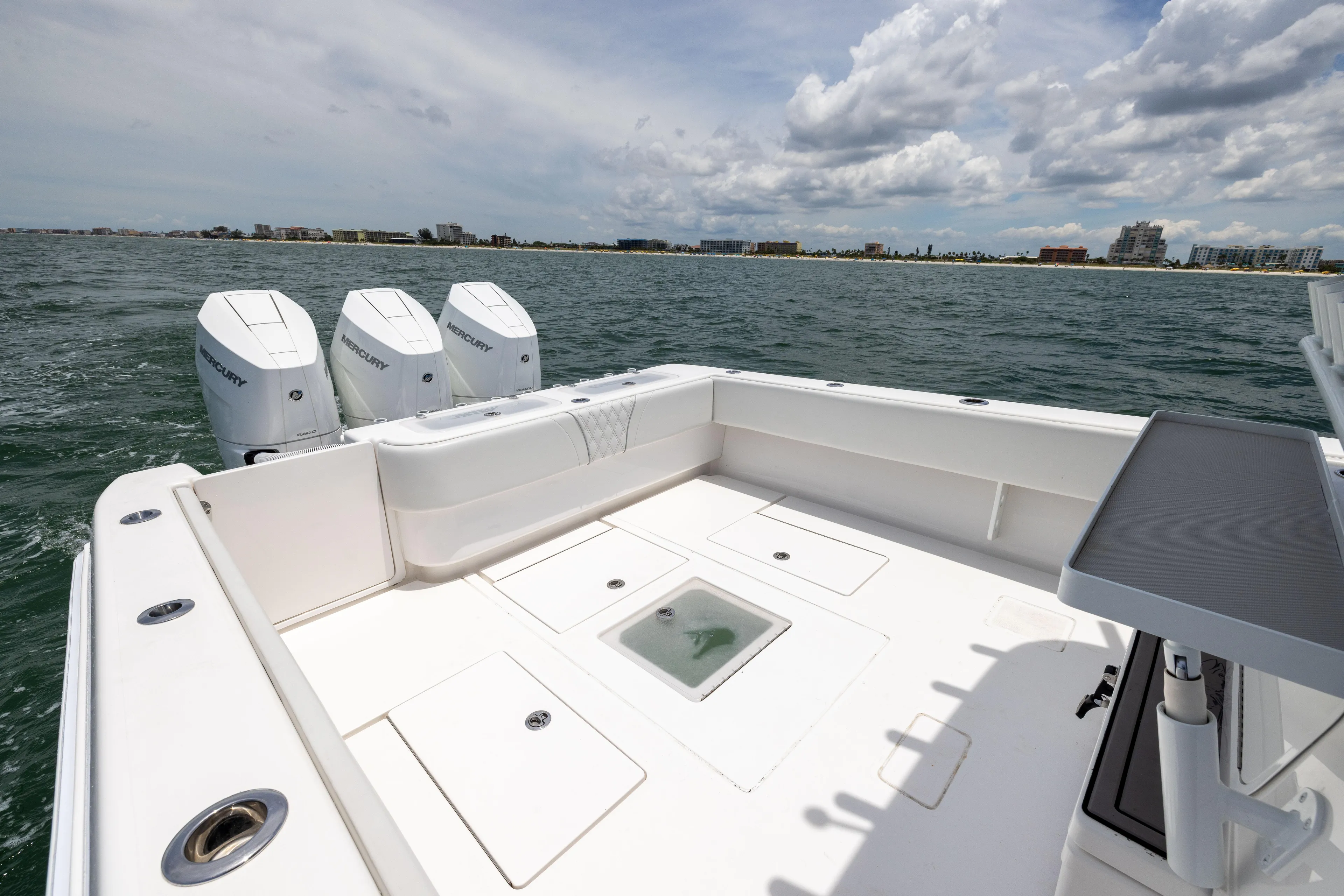  Yacht Photos Pics 2024 Contender 39 ST boat with triple Mercury engines on open water.