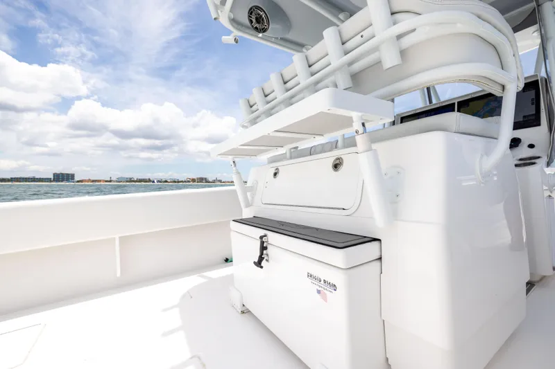  Yacht Photos Pics 2024 Contender 39 ST boat interior with seating and storage, ocean view in background.