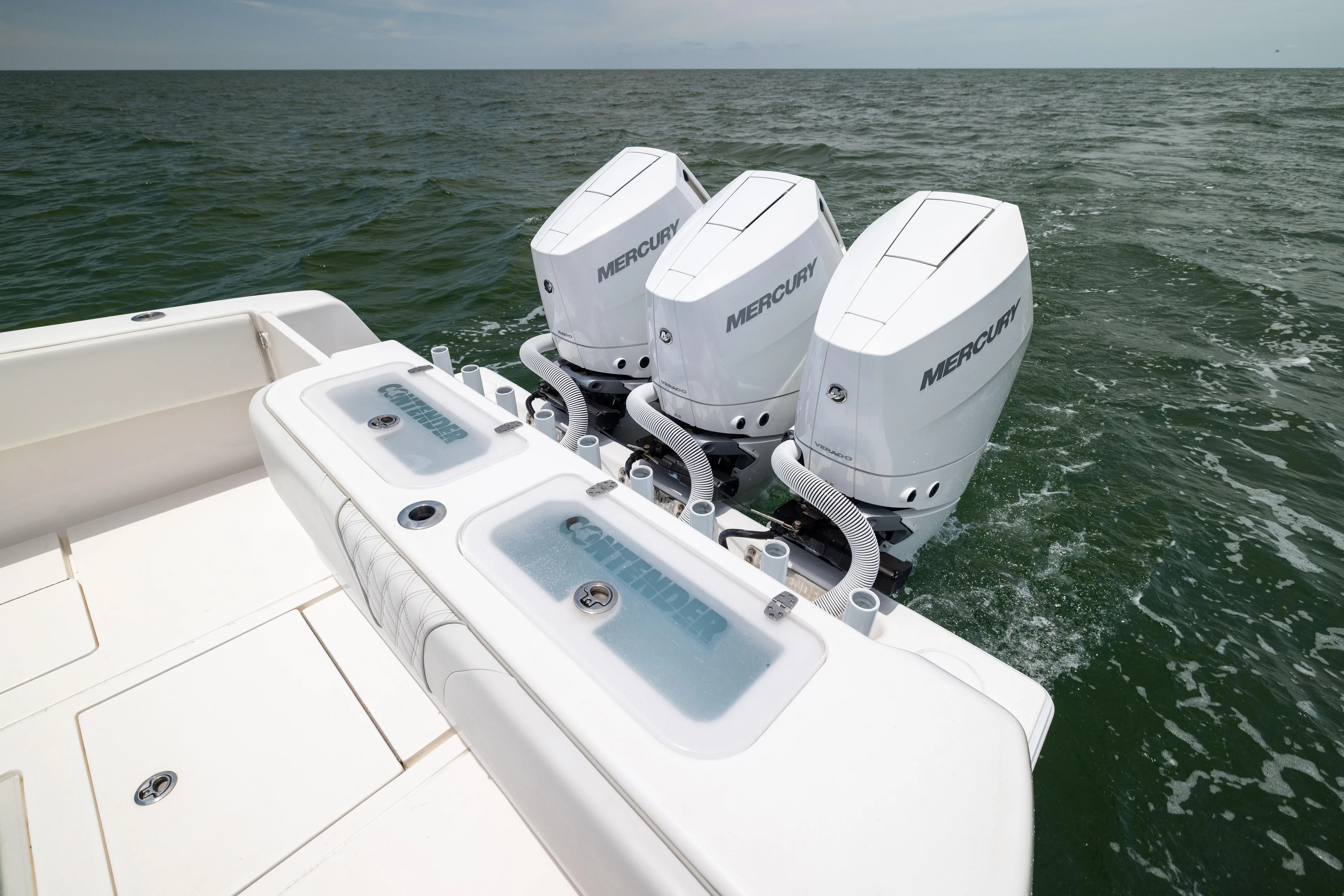  Yacht Photos Pics 2024 Contender 39 ST boat with triple Mercury outboard engines on open water.