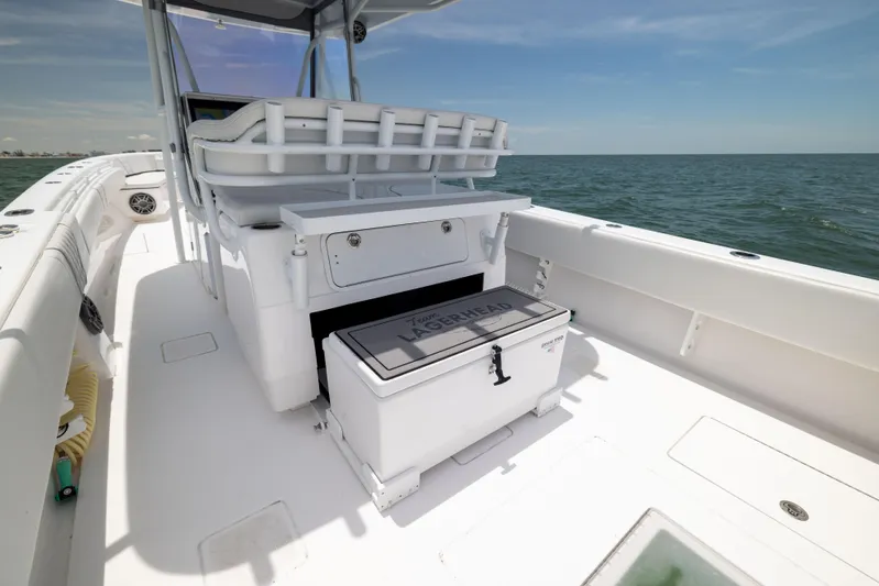  Yacht Photos Pics 2024 Contender 39 ST boat interior with seating and storage, cruising on open water.