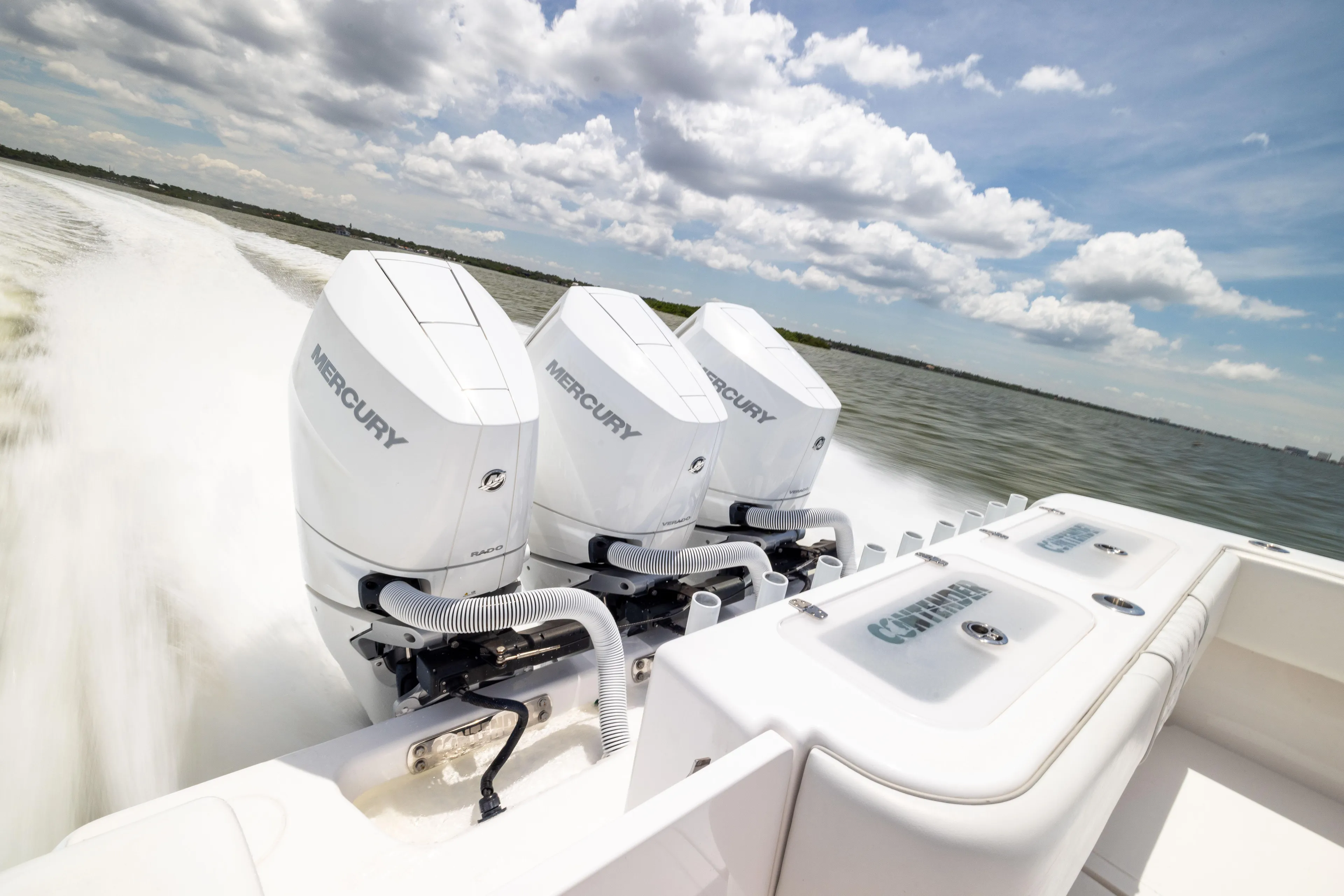  Yacht Photos Pics 2024 Contender 39 ST boat with triple Mercury engines speeding on water.