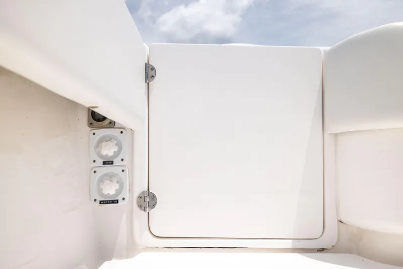  Yacht Photos Pics 2024 Contender 39 ST boat hatch and water inlet under a clear sky.