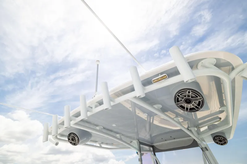  Yacht Photos Pics 2024 Contender 39 ST boat roof with rod holders and speakers against a cloudy sky.