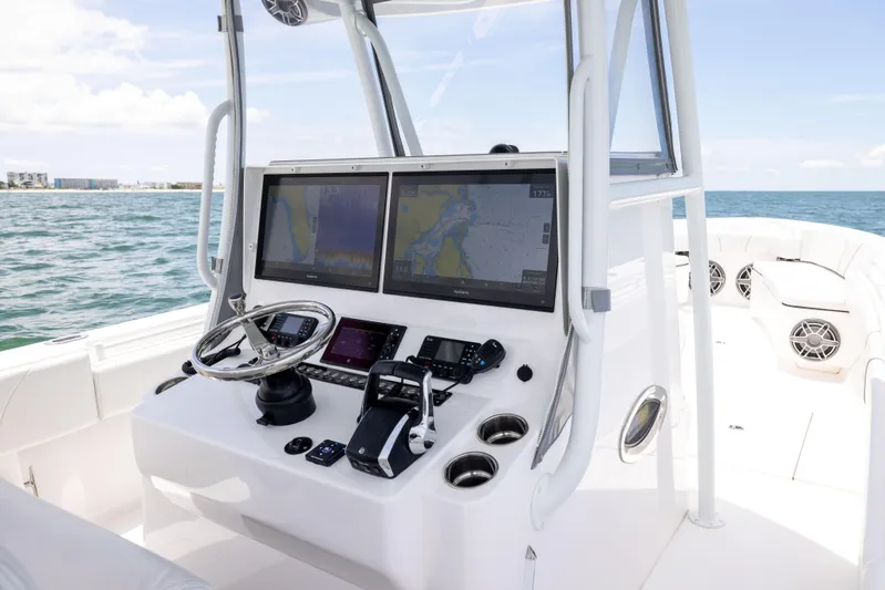  Yacht Photos Pics 2024 Contender 39 ST boat cockpit with dual navigation screens and steering wheel.