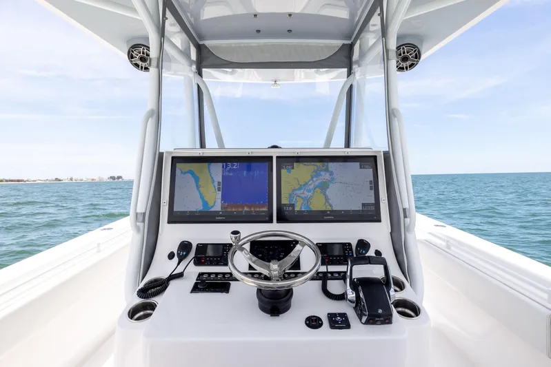  Yacht Photos Pics 2024 Contender 39 ST boat dashboard with dual navigation screens on open water.