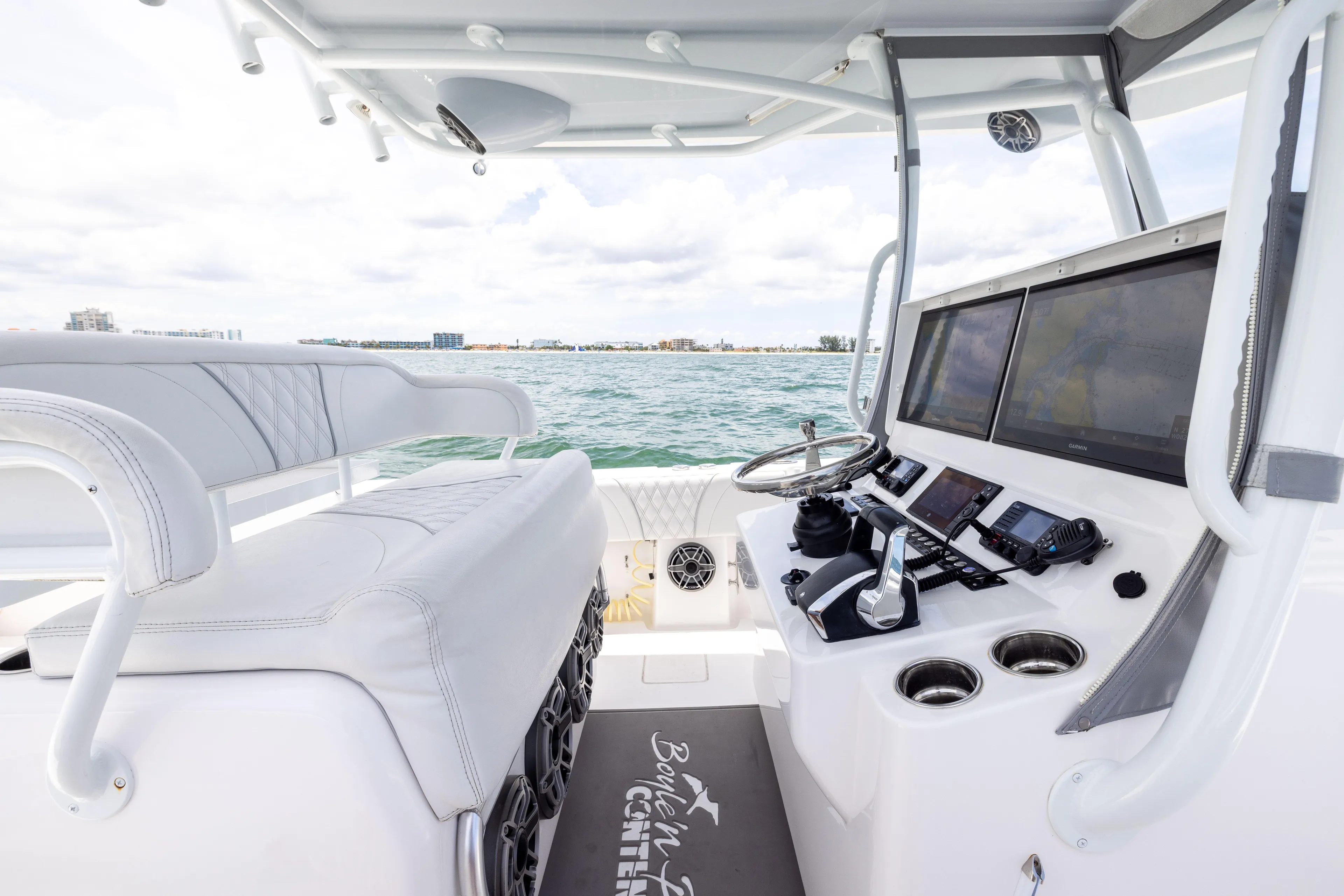  Yacht Photos Pics 2024 Contender 39 ST boat cockpit with modern controls and ocean view.