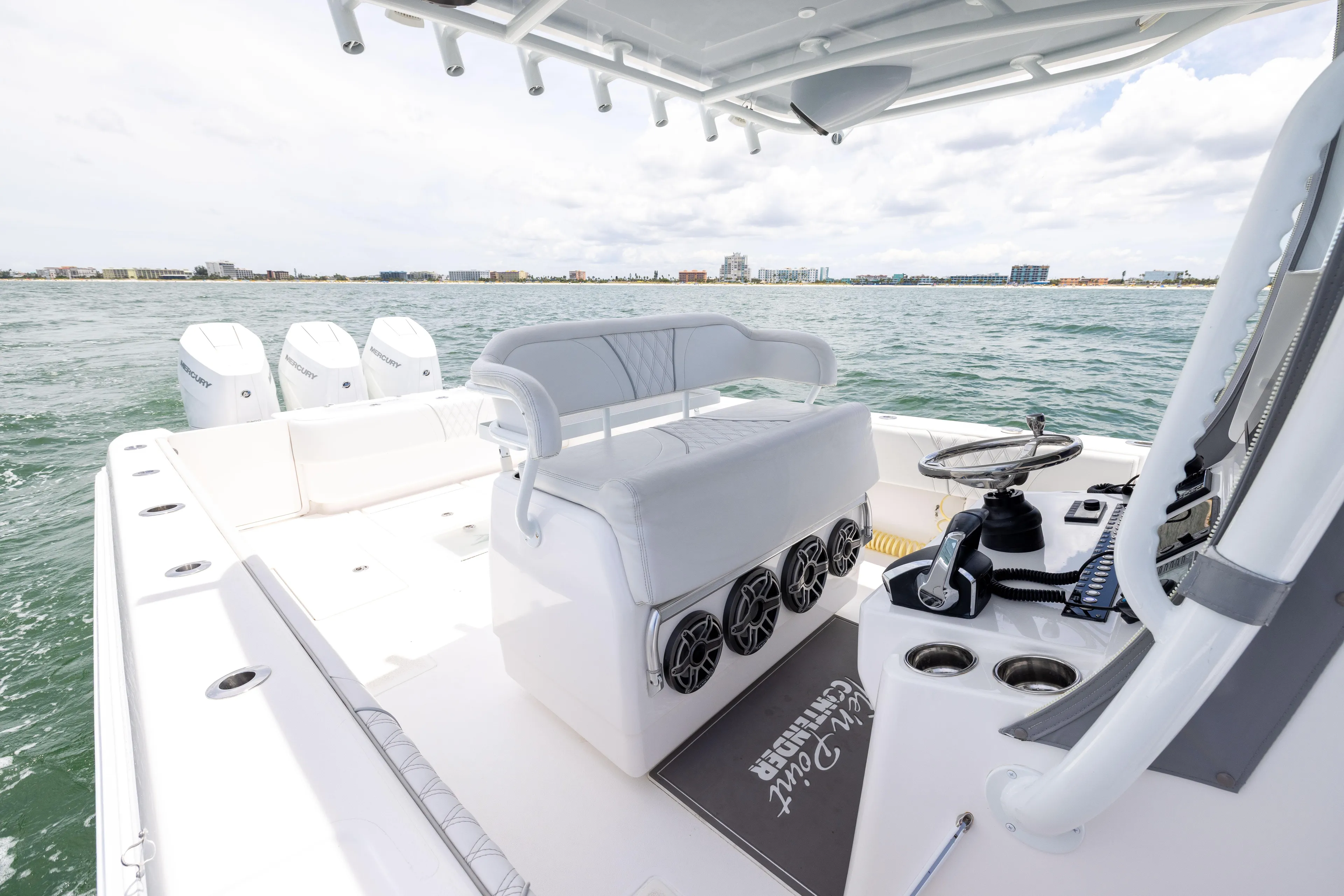  Yacht Photos Pics 2024 Contender 39 ST boat interior with seating and controls on open water.