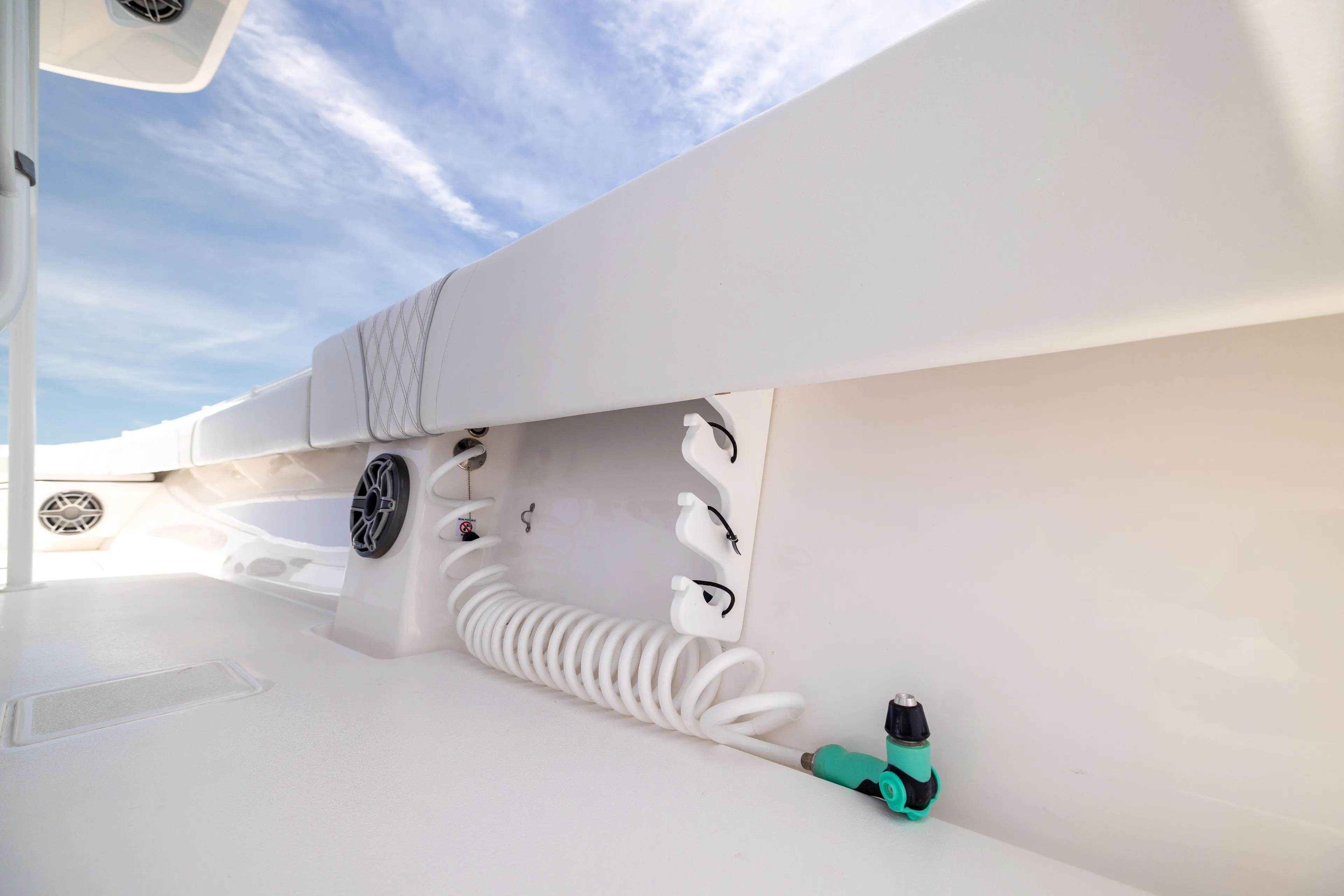  Yacht Photos Pics 2024 Contender 39 ST boat deck with coiled hose and speakers under blue sky.