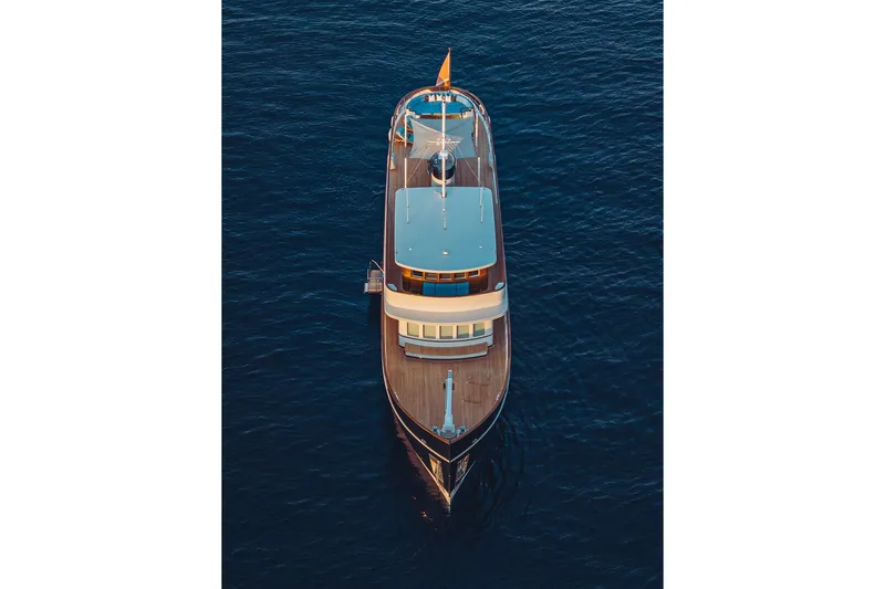 Far Niente Yacht Photos Pics 2024 Hoek Design Custom Modern Classic motor yacht on calm blue water.