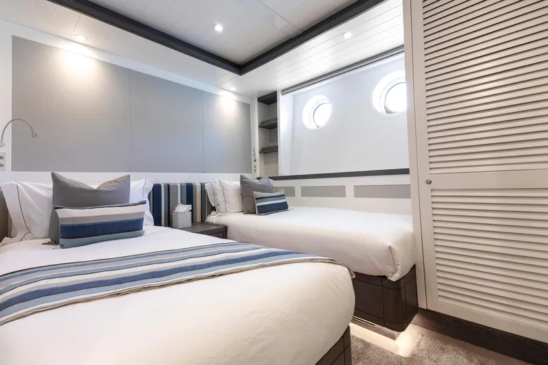 Far Niente Yacht Photos Pics Luxurious 2024 Hoek Design Motor Yacht bedroom with twin beds and nautical decor.