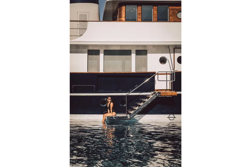 Far Niente Yacht Photos Pics Person relaxing on a 2024 Hoek Design Motor Yacht, Custom Modern Classic.