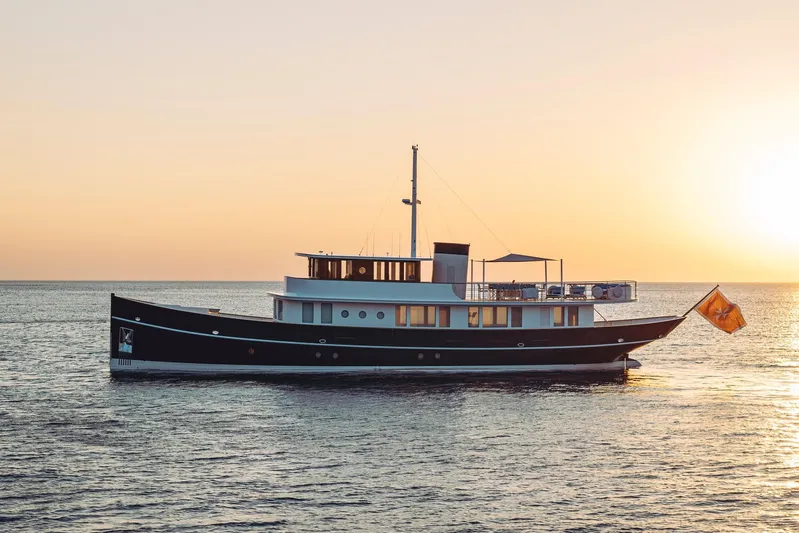 Far Niente Yacht Photos Pics 2024 Hoek Design Motor Yacht, Custom Modern Classic, at sunset on calm sea.