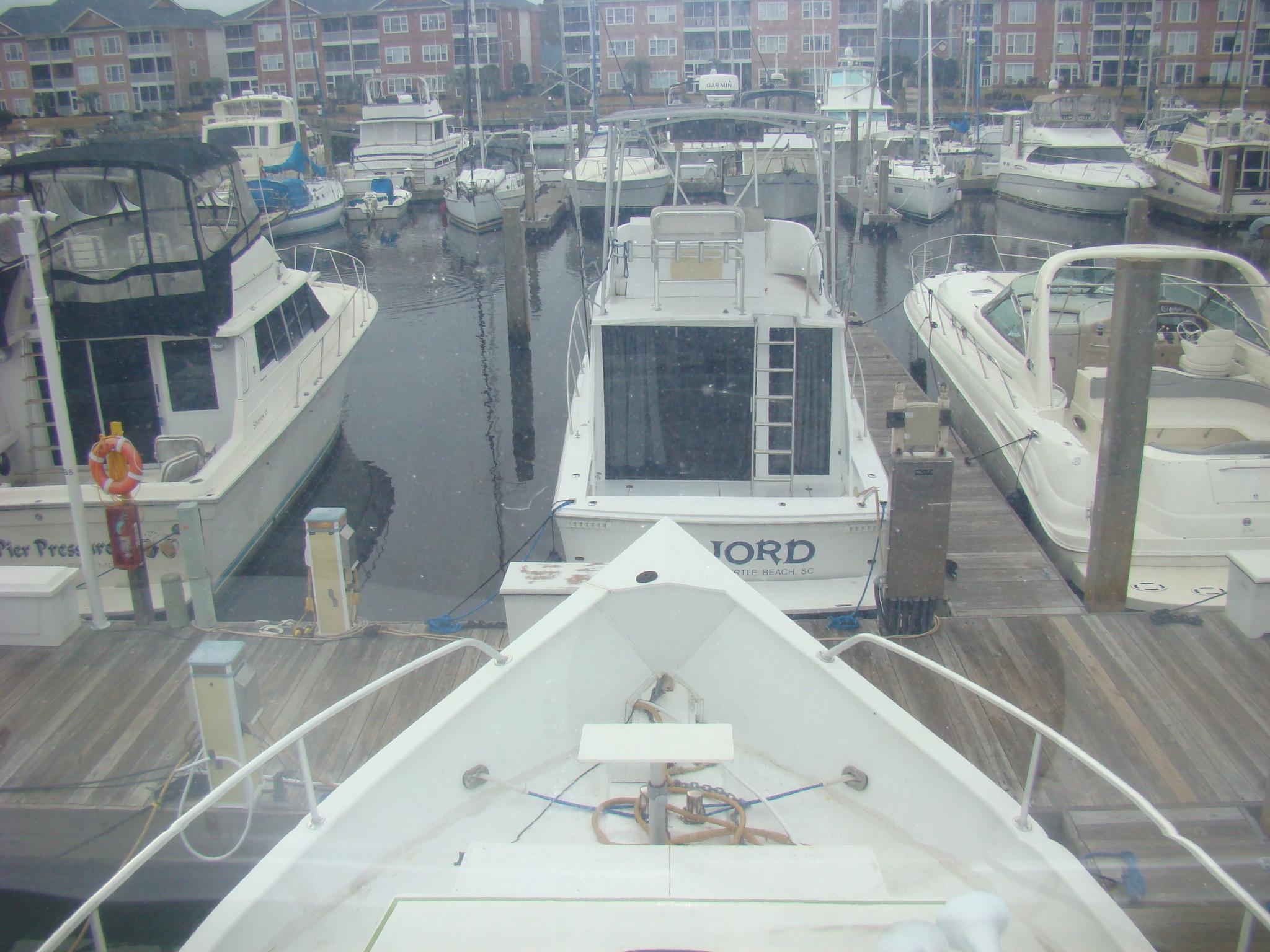 1991 Custom Trawler docked in a marina with other boats.
