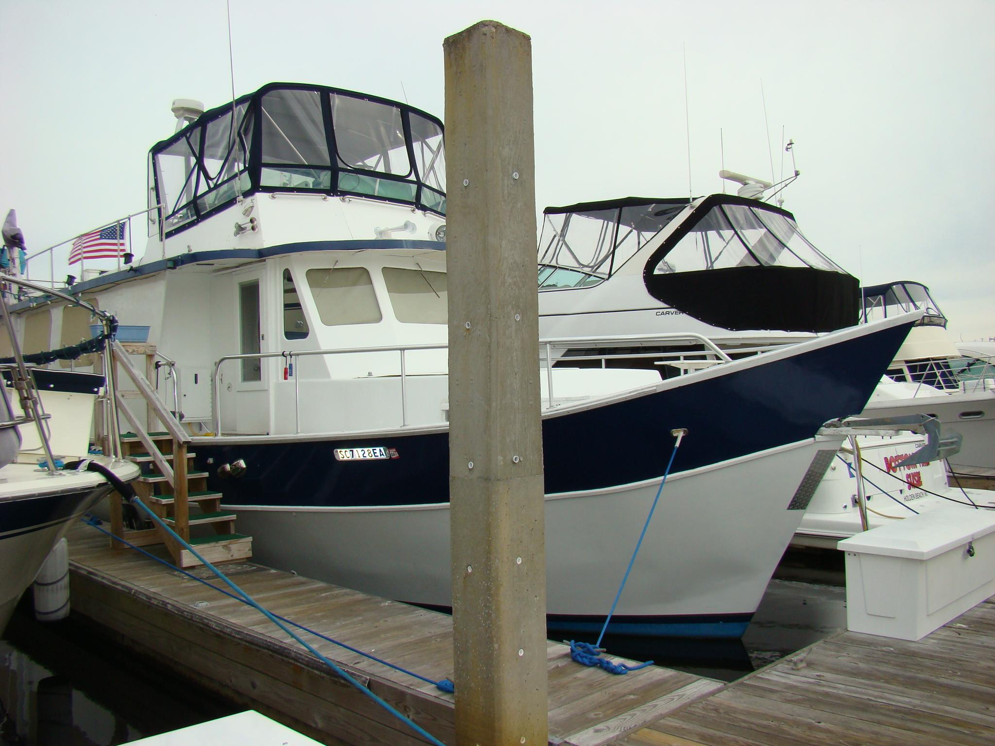 Custom 1991 Trawler docked at marina with other boats.