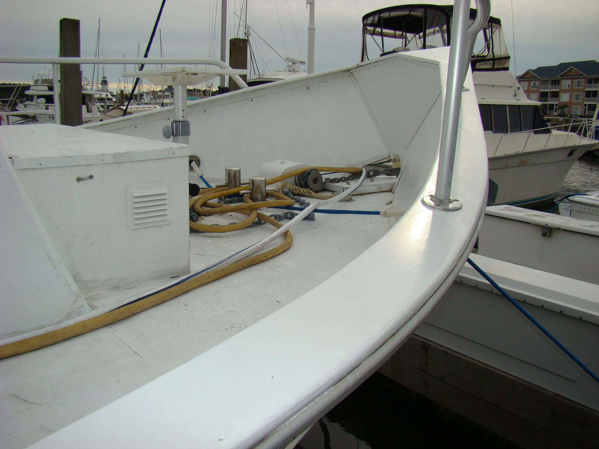 1991 Custom Trawler boat docked at marina with equipment on deck.