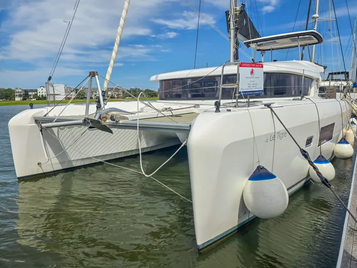 Le Tigre Yacht Photos Pics 2019 Lagoon 42 catamaran docked, featuring sleek design and modern amenities.