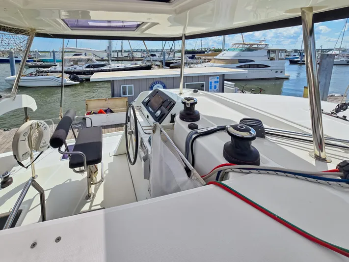 Le Tigre Yacht Photos Pics Helm of 2019 Lagoon 42 catamaran at marina, showcasing modern navigation equipment.