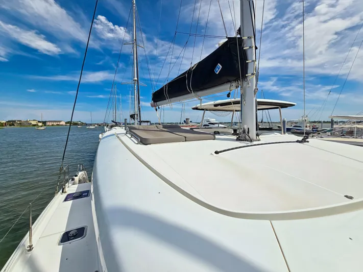 Le Tigre Yacht Photos Pics 2019 Lagoon 42 catamaran on calm waters under a clear blue sky.