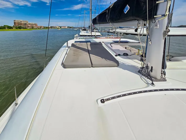 Le Tigre Yacht Photos Pics 2019 Lagoon 42 catamaran on calm water, featuring spacious deck and sleek design.