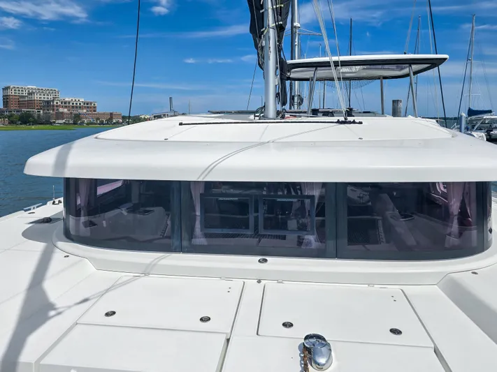 Le Tigre Yacht Photos Pics 2019 Lagoon 42 catamaran with sleek design, docked under a clear blue sky.