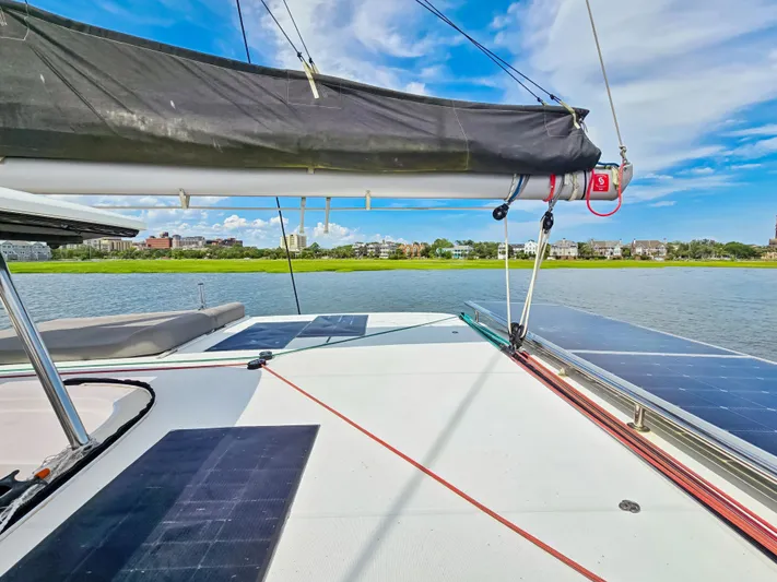 Le Tigre Yacht Photos Pics 2019 Lagoon 42 catamaran deck with solar panels, sailing on a sunny day.
