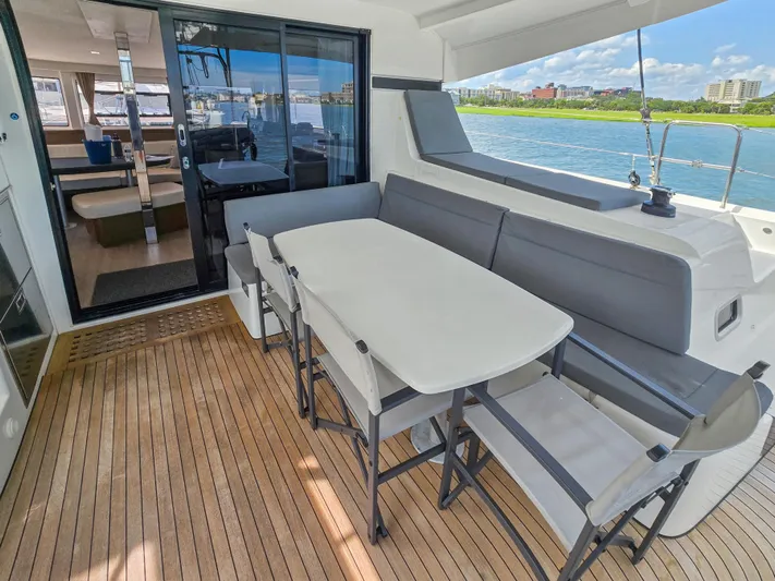 Le Tigre Yacht Photos Pics 2019 Lagoon 42 yacht deck with seating area, table, and ocean view.