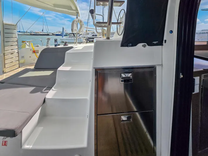Le Tigre Yacht Photos Pics 2019 Lagoon 42 yacht interior with stairs, seating, and stainless steel storage.