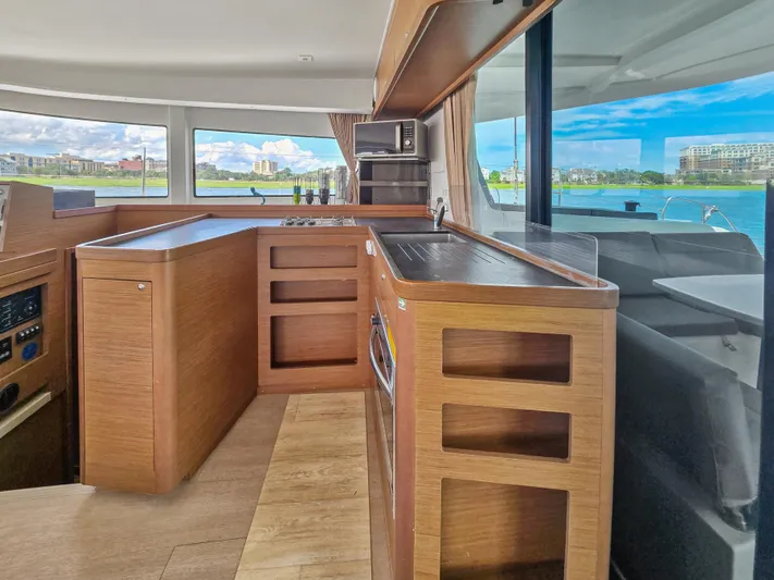 Le Tigre Yacht Photos Pics Interior of 2019 Lagoon 42 catamaran with modern kitchen and scenic water view.