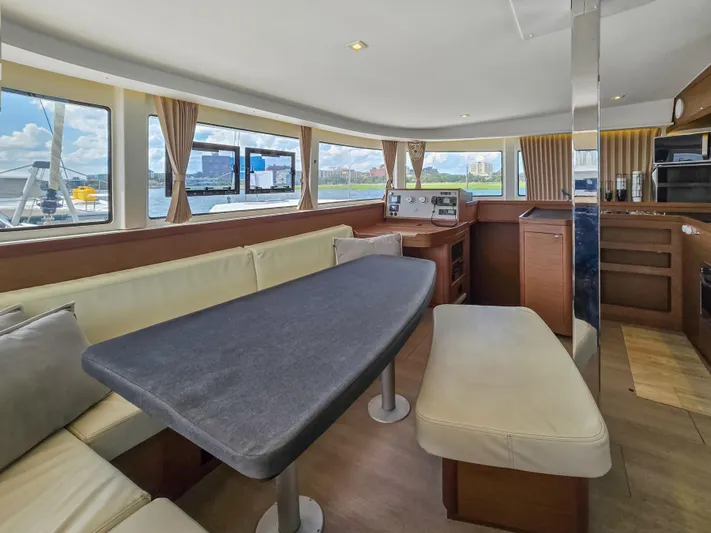 Le Tigre Yacht Photos Pics Luxurious interior of 2019 Lagoon 42 catamaran with spacious seating and panoramic windows.